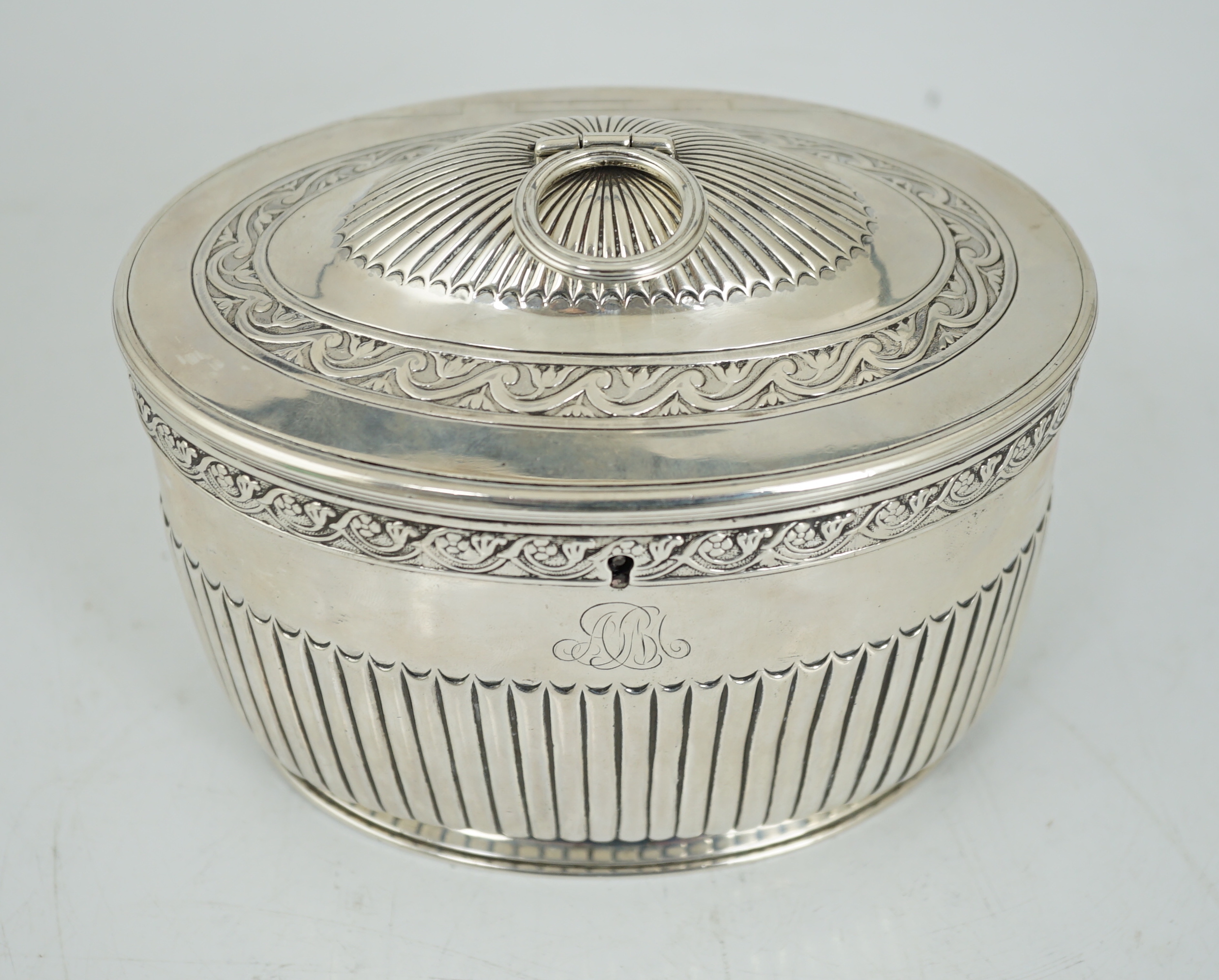 A George III demi fluted silver oval tea caddy by Andrew Fogelberg & Stephen Gilbert
